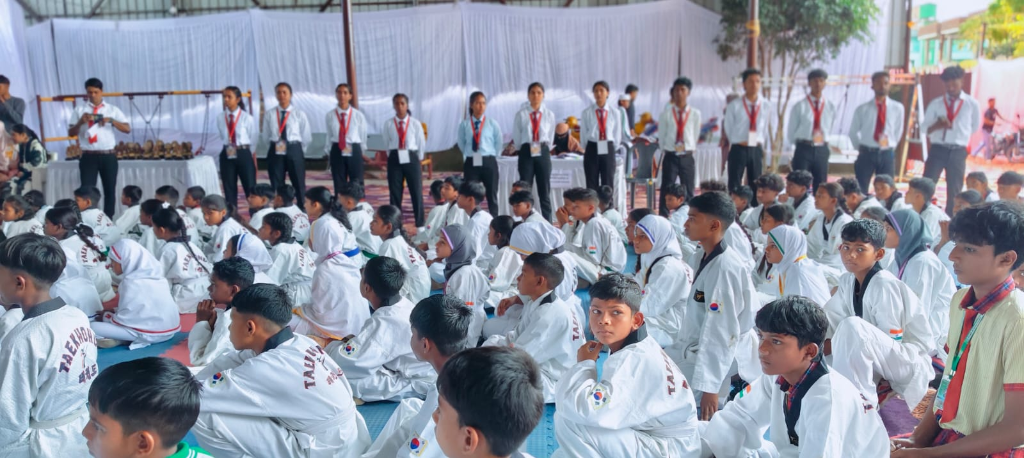 Taekwondo students and coaches gathered at an academy event